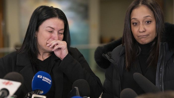 Two women, including one in tears, in the corridors of the courthouse.