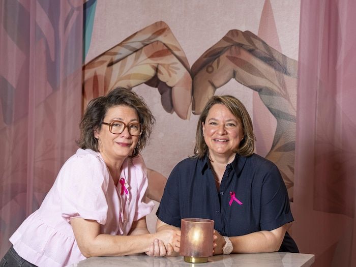 The two women sat down at a table.