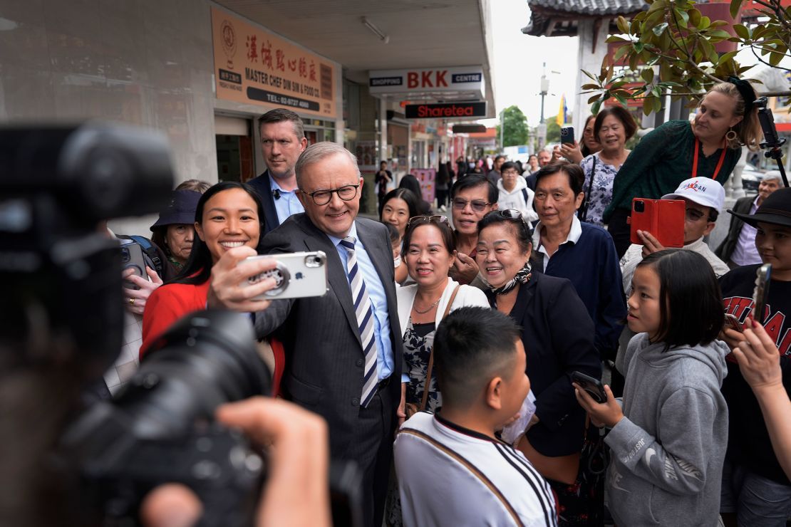 Australian Prime Minister Anthony Albanese and Labor Candidate Tu Le take a selfie with members of the public during a visit to Freedom Plaza in the electorate of Fowler in Sydney, Australia, on April 28.