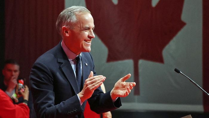 Mark Carney applauds.