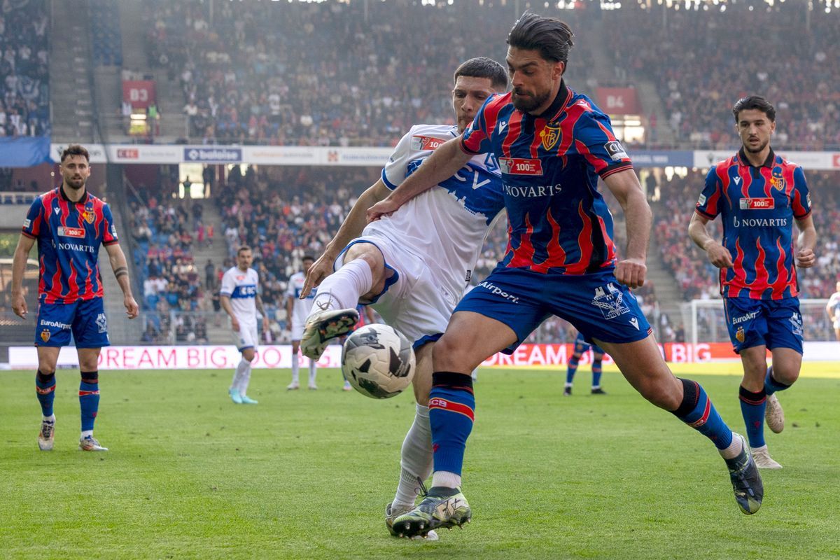 Schweizer Cup football match in Basel between FC Basel and FC Lausanne-Sport. Alban Ajdini de Lausanne tries to pass Nicolas Vouilloz de Basel. Schweizer Cup football match in Basel between FC Basel and FC Lausanne-Sport. Alban Ajdini de Lausanne tries to pass Nicolas Vouilloz de Basel.