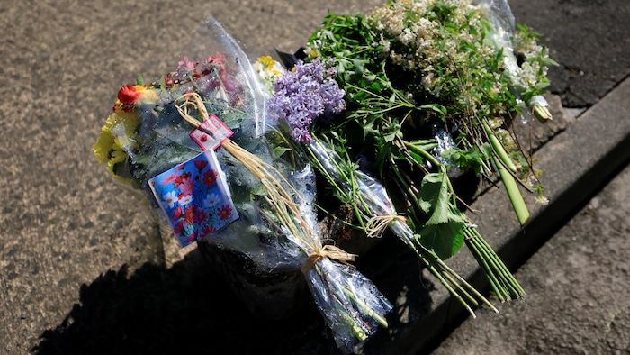 Bouquets of flowers placed on the ground.