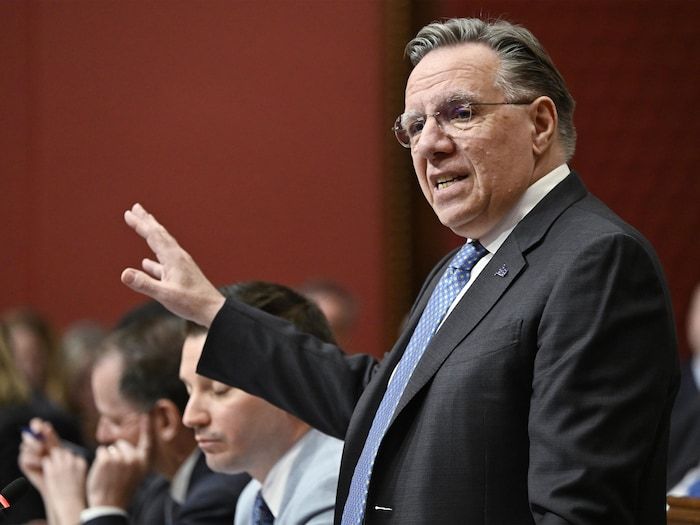 François Legault speaks, standing in bedroom.