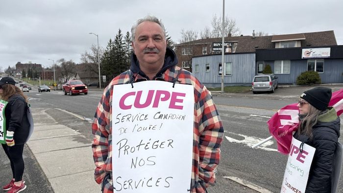 Paul Lafrenière, an employee of Canadian Hearing Services in Sudbury, standing with a striker.
