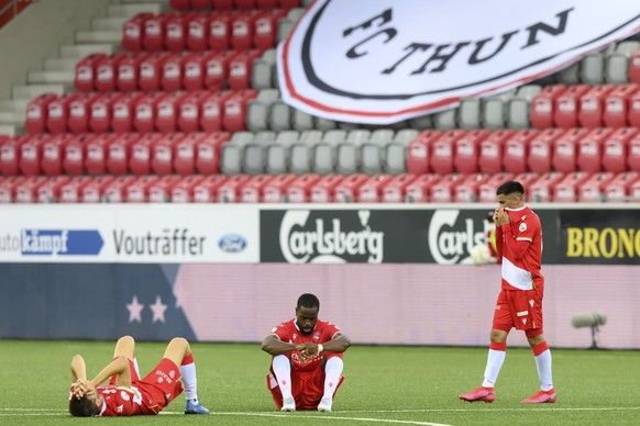 Thuns Simone Rapp, Thuns Ridge Munsy, Thuns Hiran Ahmed, from left, react after the defeat, in football Barrage Rueckpiel between FC Thun from the Super League and FC Vaduz from the Cha ...