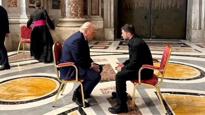 Volodymyr Zelensky and Donald Trump sitting face-to-face in the Saint-Pierre basilica.
