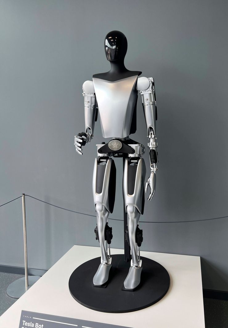 A Tesla Bot Optimus humanoid robot with IA, exposed at the entrance to the Tesla showroom in Munich for visitors inspection on May 22, 2024. A Tesla Bot Optimus humanoid robot with IA, exposed at the entrance to the Tesla showroom in Munich for visitors inspection on May 22, 2024.