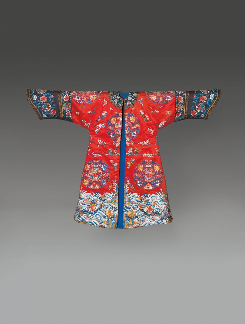 Traditional red Asian dress decorated with colored patterns and detailed embroidery. Traditional red Asian dress decorated with colored patterns and detailed embroidery.