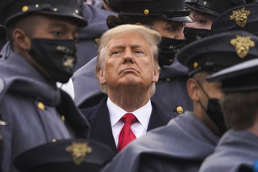 FILE - Surrounded by Army cadets, President Donald Trump watches the first half of the 121st Army-Navy Football Game, Dec. 12, 2020, in West Point, N.Y. When New York's Adult Survivors Act expire ...