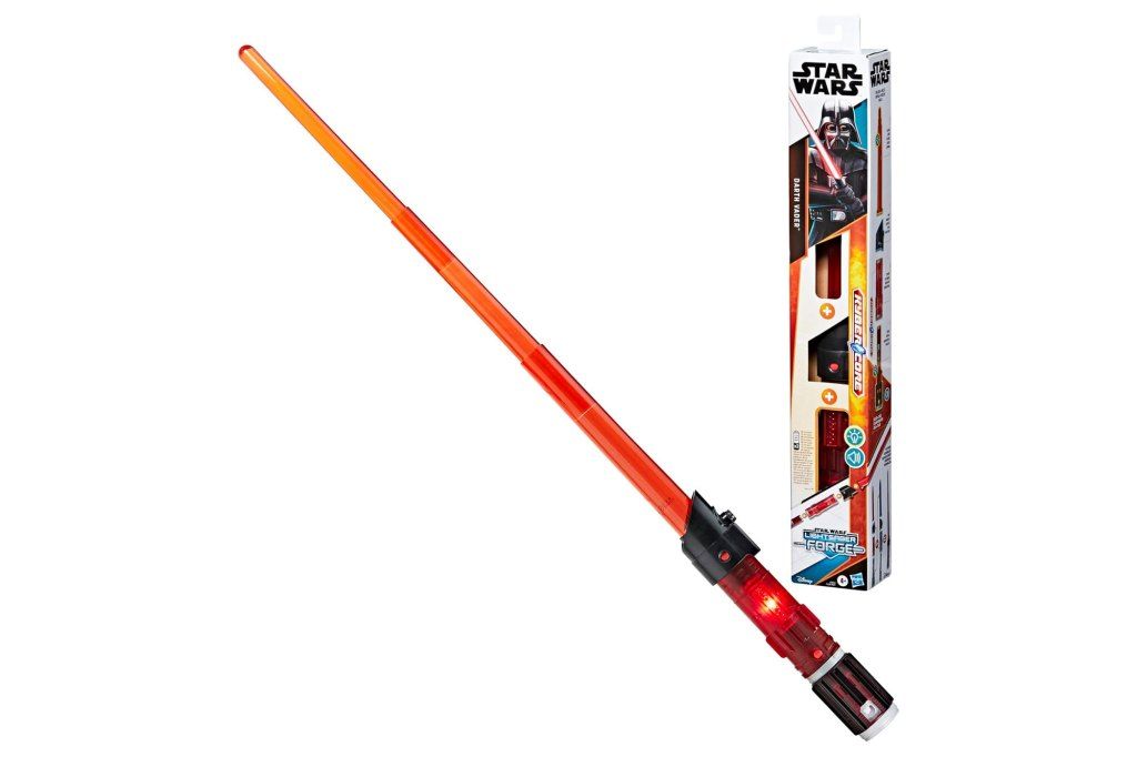 Tim Jennings holding a toy lightsaber with its box