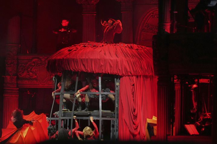 Lady Gaga dancers hidden under her huge red dress.