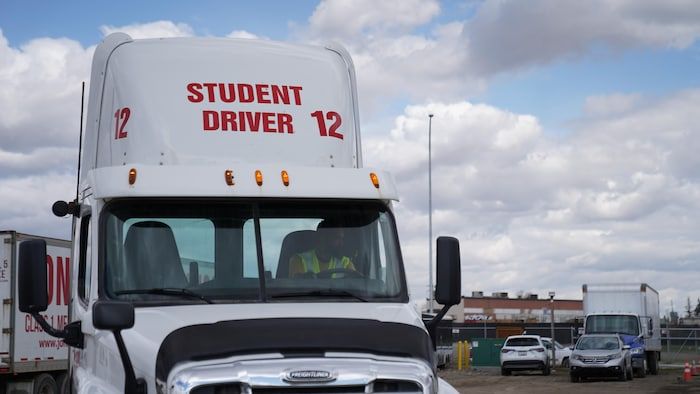 A trailer truck head from the Jonas Driving School school led by an employee of the school.