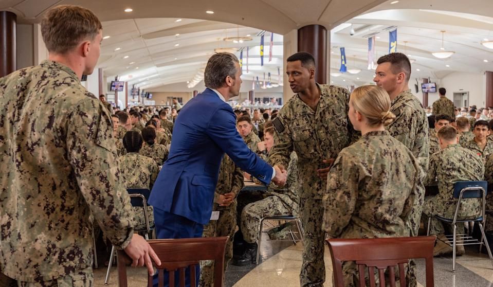 Secretary of Defense Pete Hegseth shakes hands with US Naval Academy students during a lunch at the school on April 1, 2025.